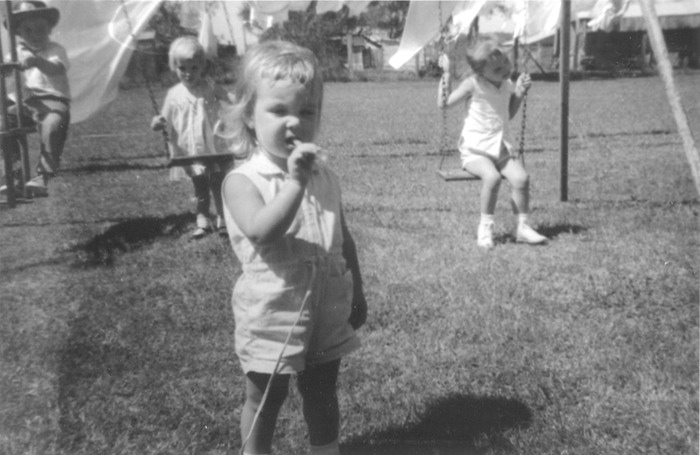 Martha in front of swing and cousins